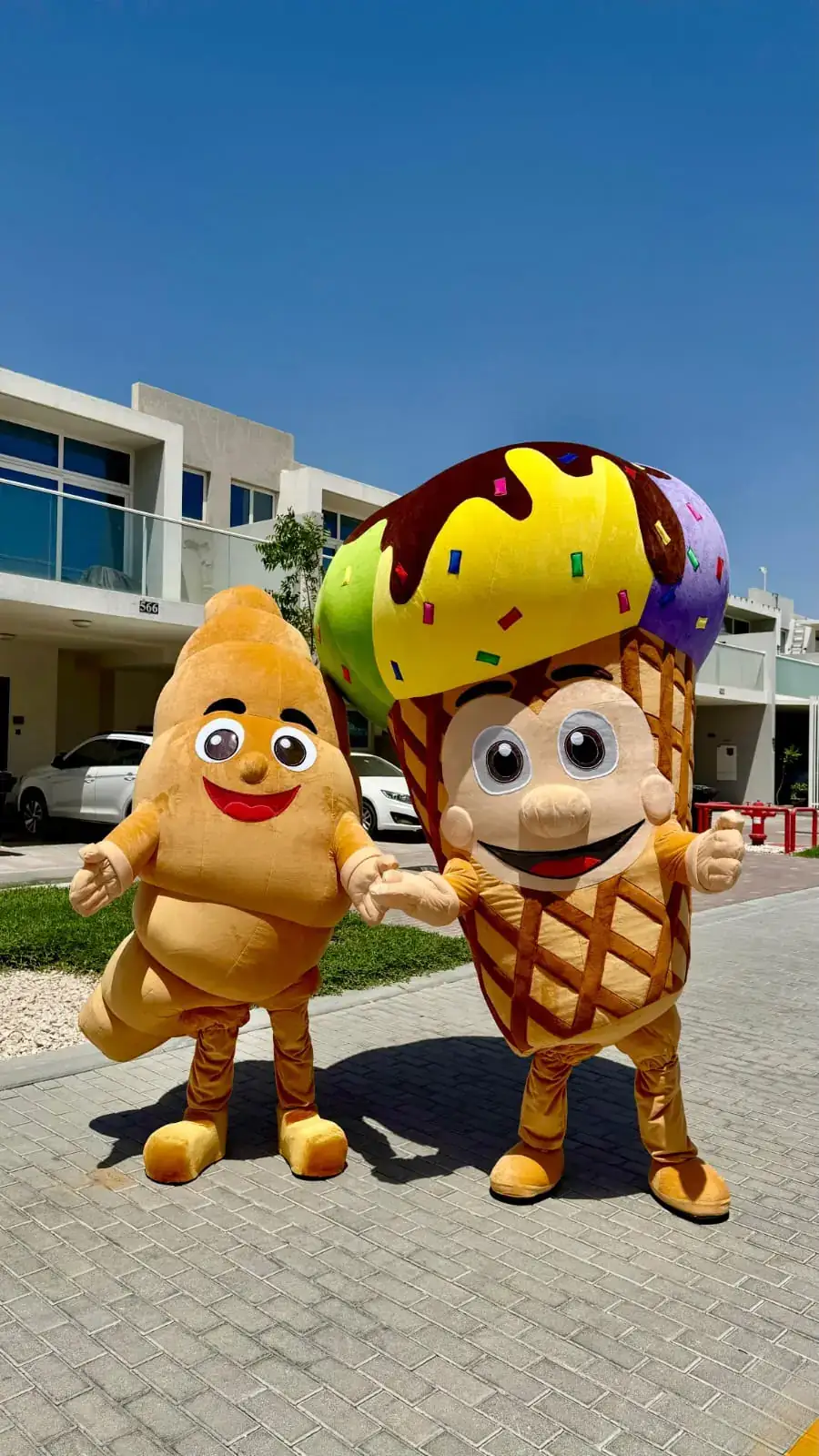 Croissant and ice cream mascots at a community event