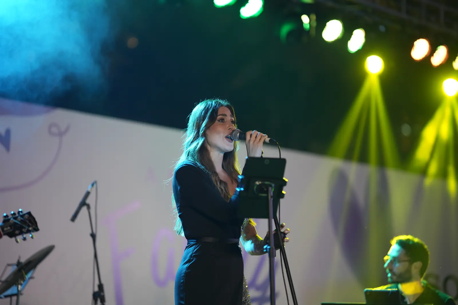 Live band singer performing on a festival stage