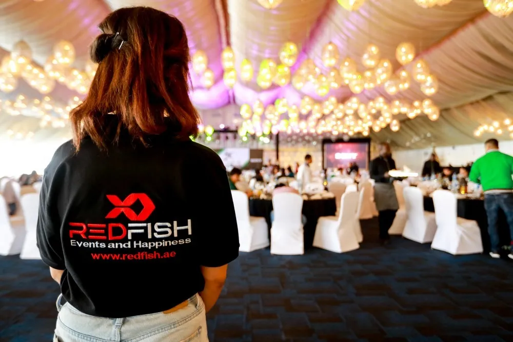 Redfish team member at a gala dinner setup