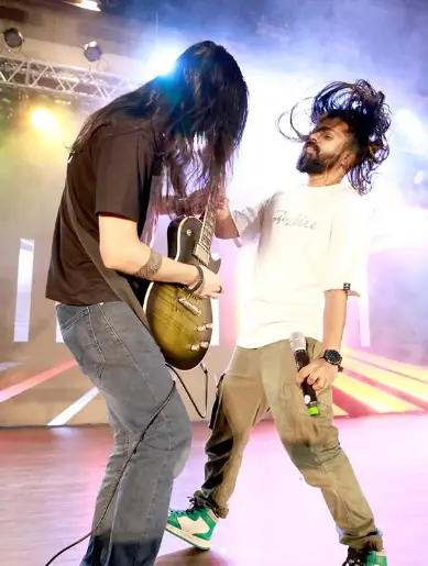 Guitarist and singer performing at a live rock show