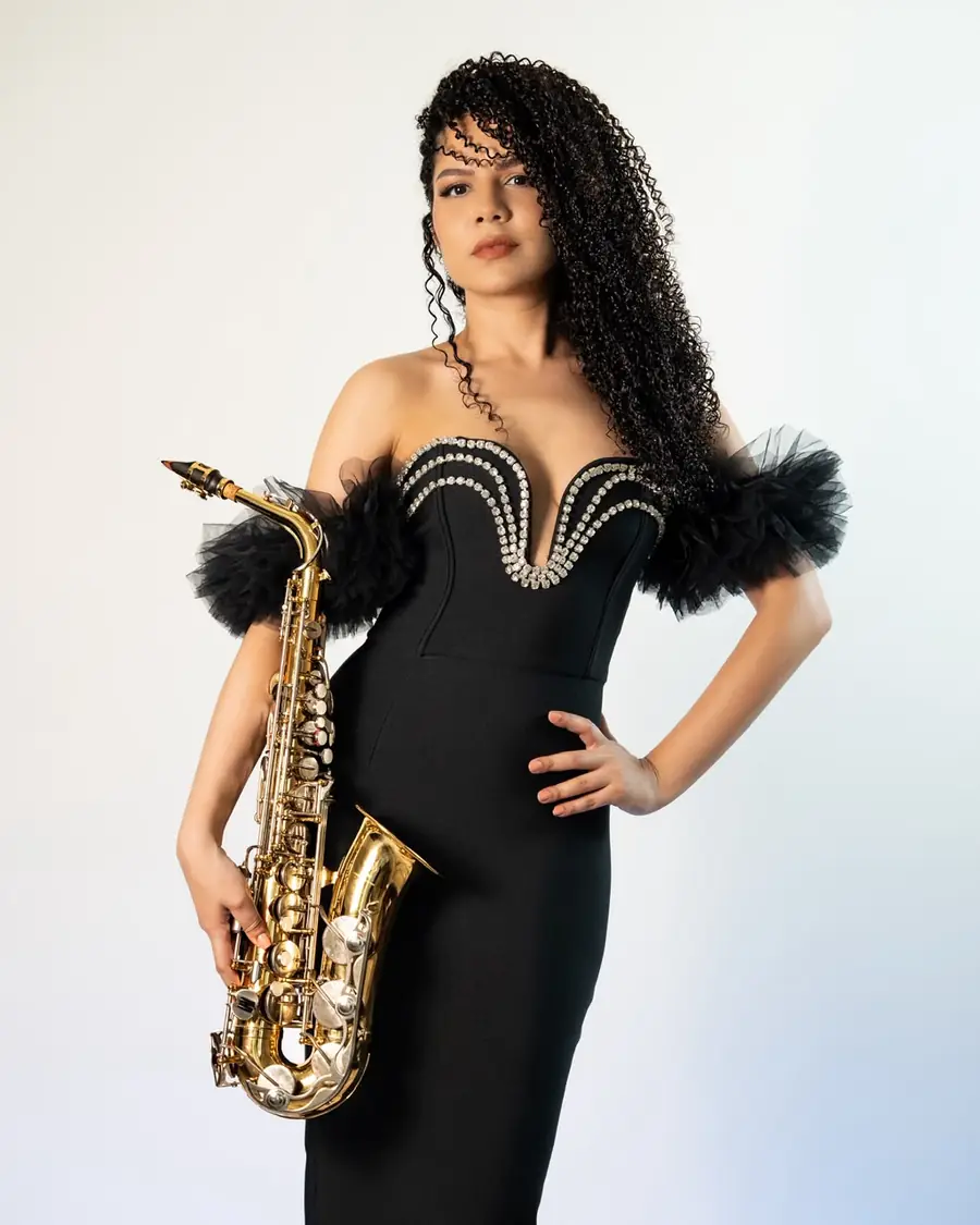 Saxophonist in a black gown at a gala event