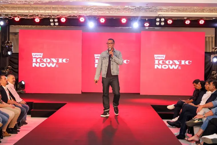 Host on a red-carpet runway at a brand launch